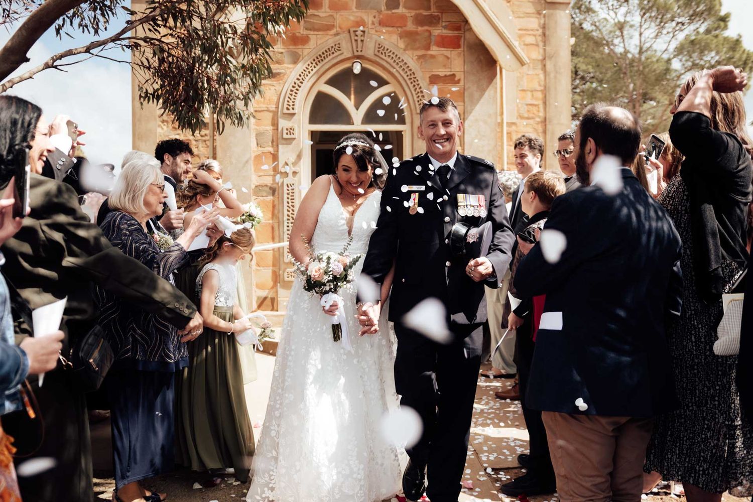 Bride and groom celebrate with guests throwing confetti at a Eudunda Church, photographed by Barossa Valley photographer Matt Webster.