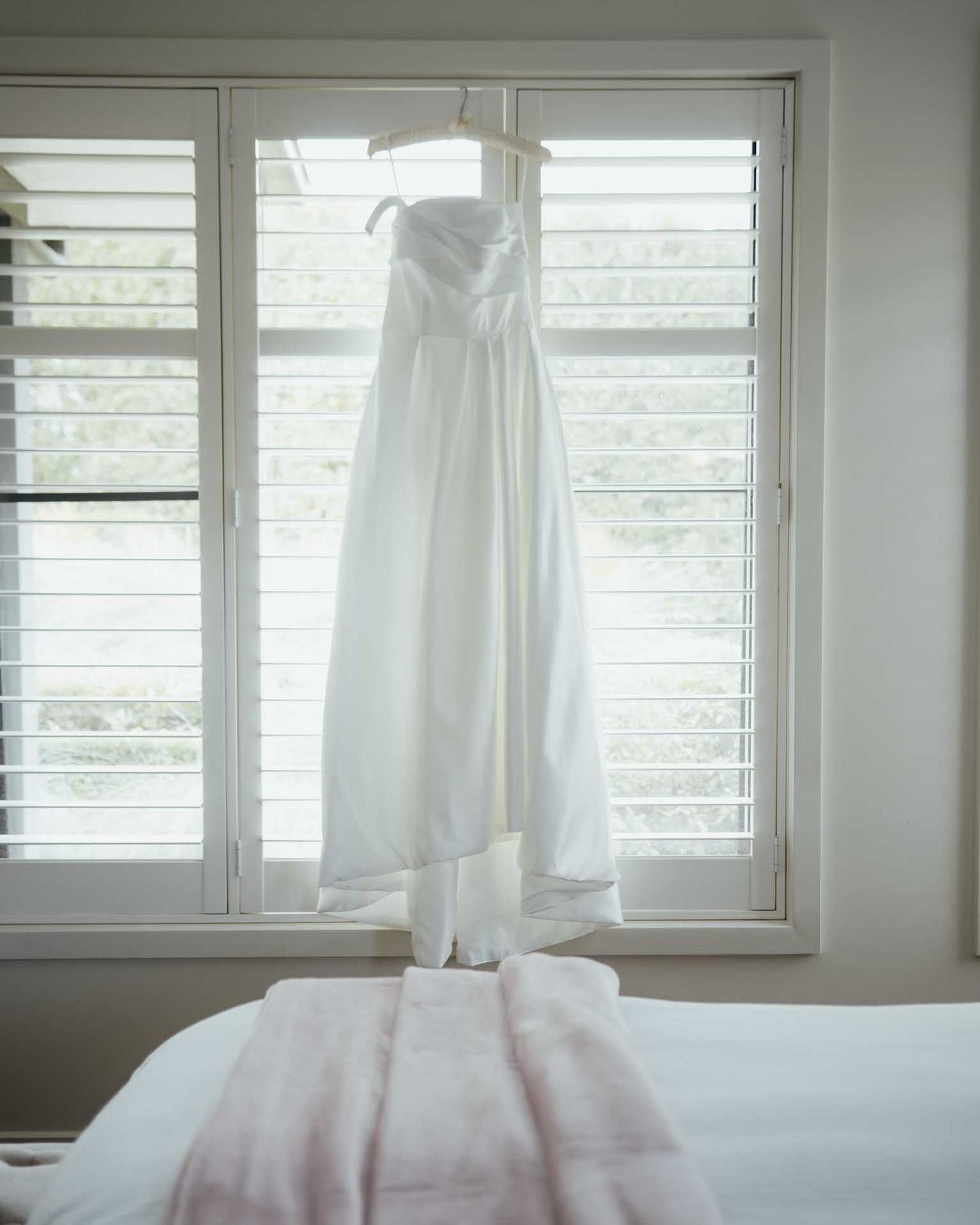 Wedding dress hanging in white room at a Barossa Valley wedding captured by Matt Webster.
