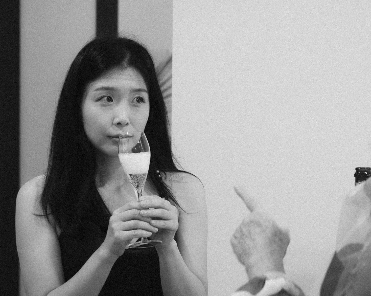 Candid moment bridesmaid holding a glass of wine during bride prep in Tanunda by Barossa Valley photographer Matt Webster