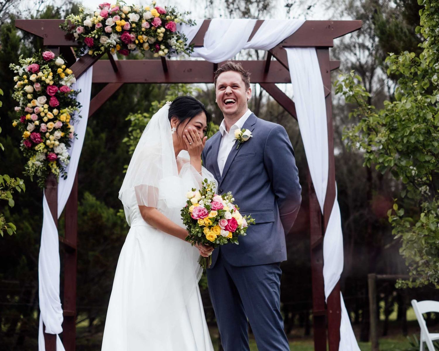 Candid moment of bride and groom laughing during their wedding ceremony in Tanunda by Barossa Valley photographer Matt Webster