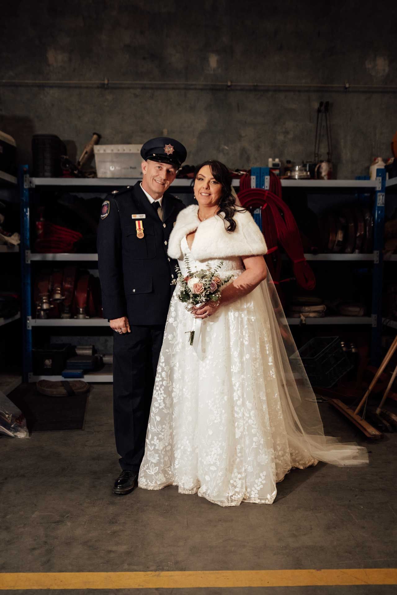 Groom in his firefighting uniform with his bride at fire station, photographed by Barossa Valley photographer Matt Webster.