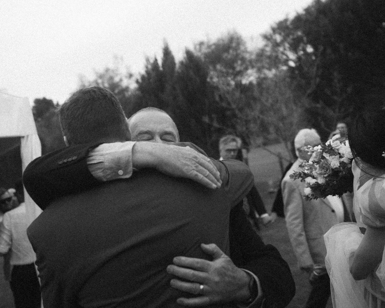Groom hugs his father at an outdoor wedding in Tanunda by Barossa Valley photographer Matt Webster