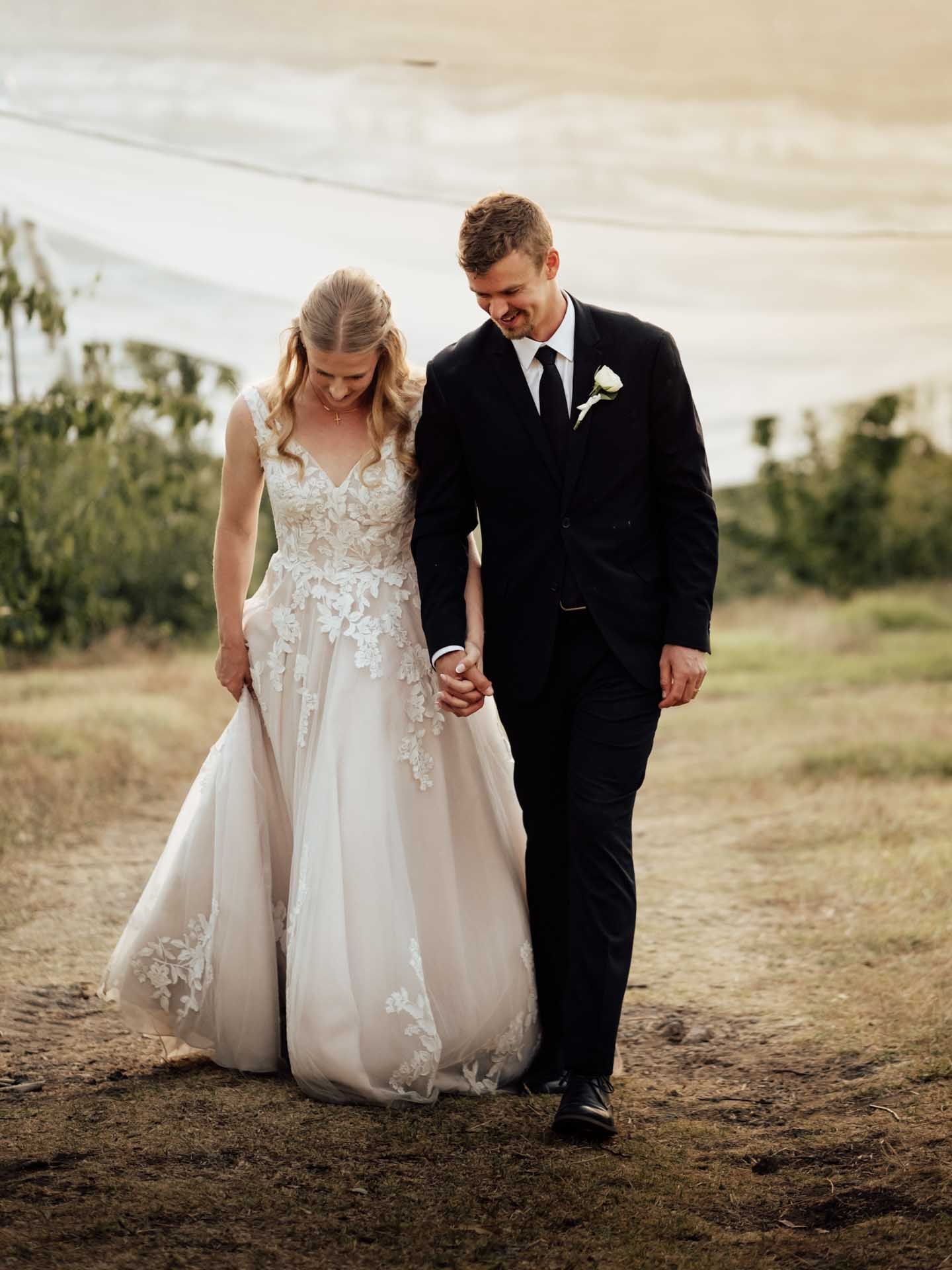 Bride and groom holding hands during sunset photos in the Adelaide Hills, photographed by Barossa Valley wedding photographer Matt Webster.