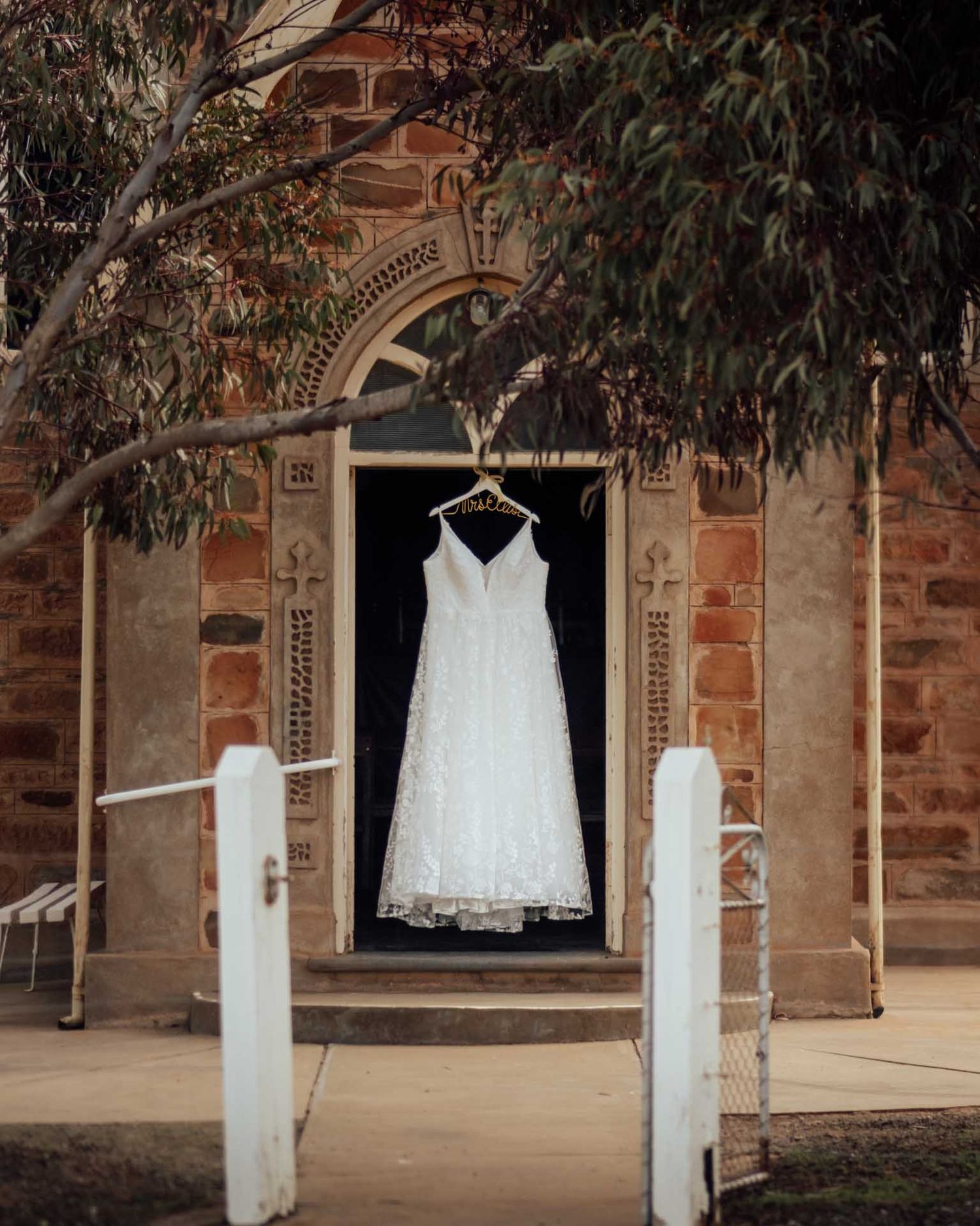 Brides wedding dress hanging outside a church in  Eudunda, photographed by Barossa Valley photographer Matt Webster.