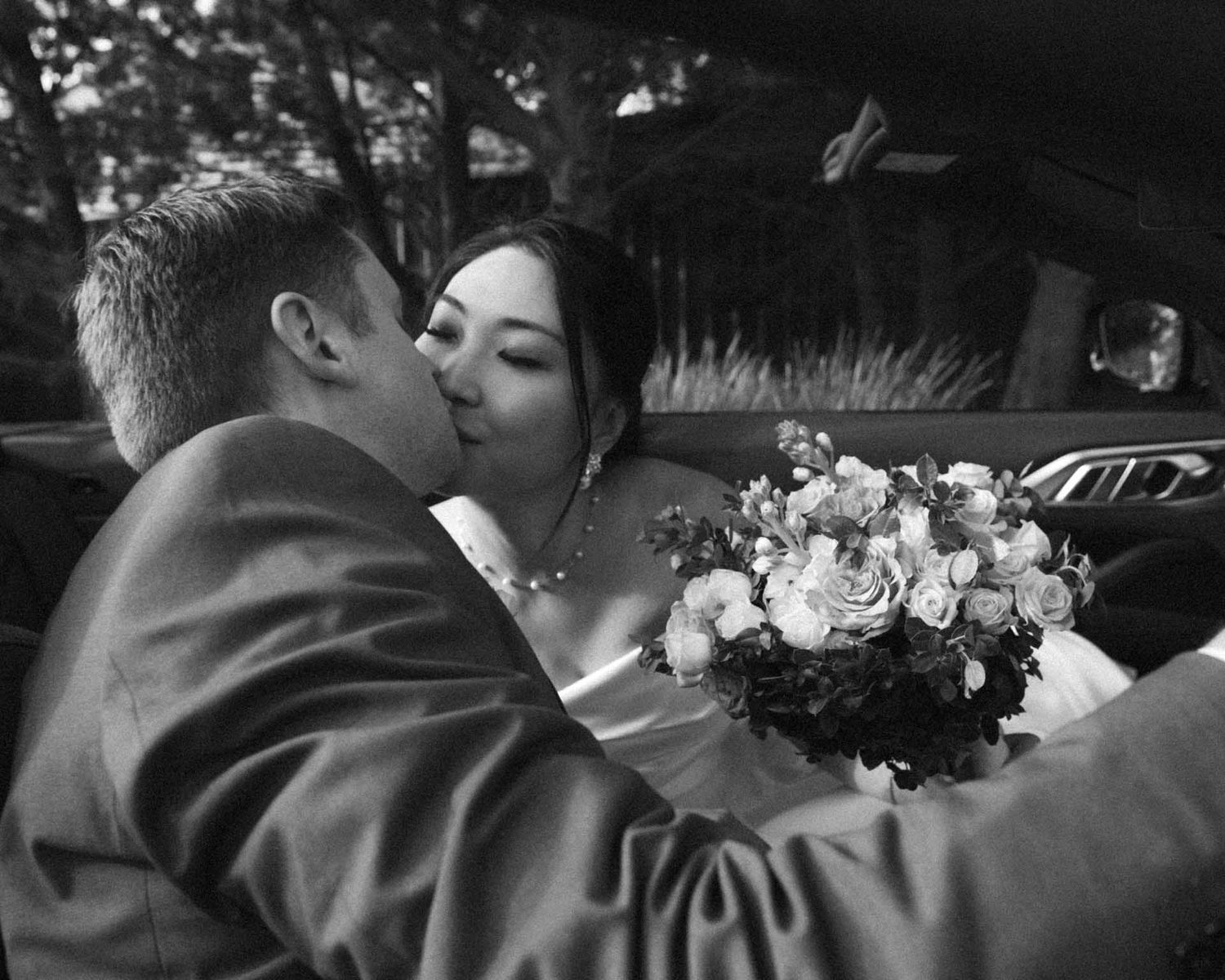 Couple portraits in their bridal car in Tanunda, shot in black and white by Barossa Valley wedding photographer Matt Webster