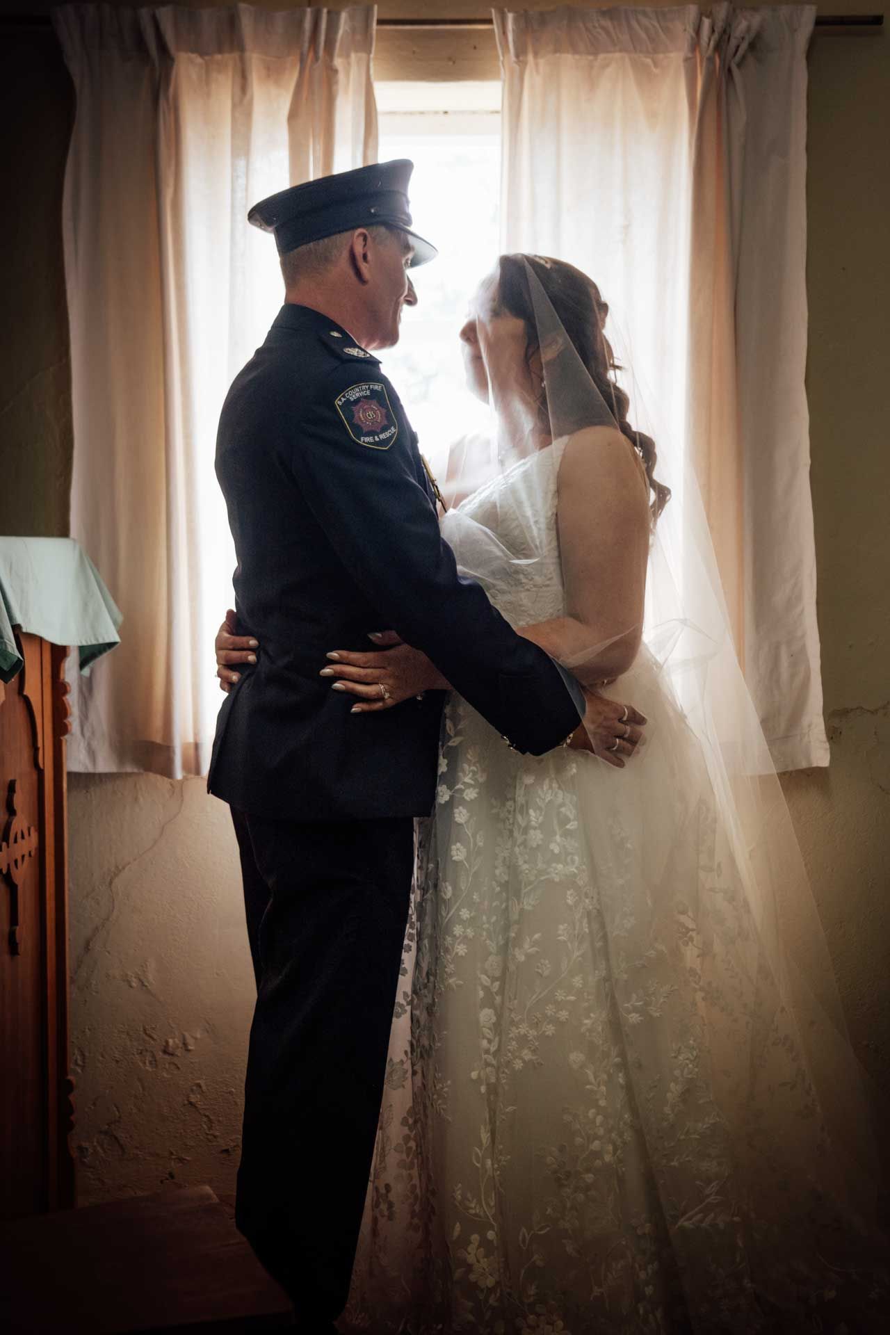 Bride and groom stare into each others eyes with natural light at Eudunda Church, photographed by Barossa Valley photographer Matt Webster.