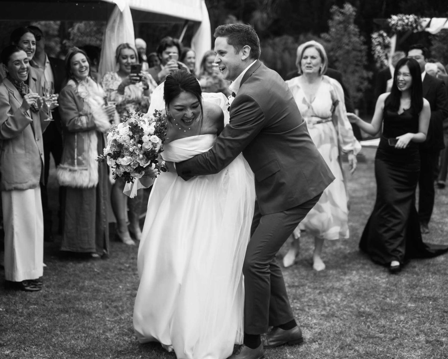 Bride and groom dancing as they walk down the isle after their outdoor wedding in Tanunda by Barossa Valley photographer Matt Webster
