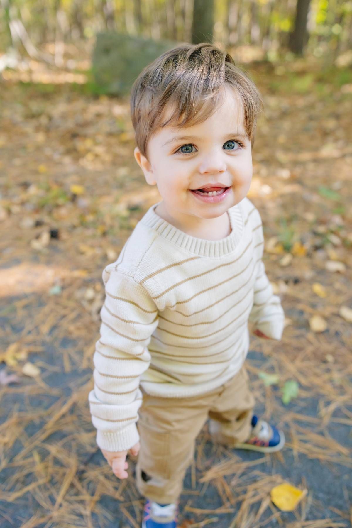 Sweet autumn outdoor photos on fallen leaves with cozy cream sweater.