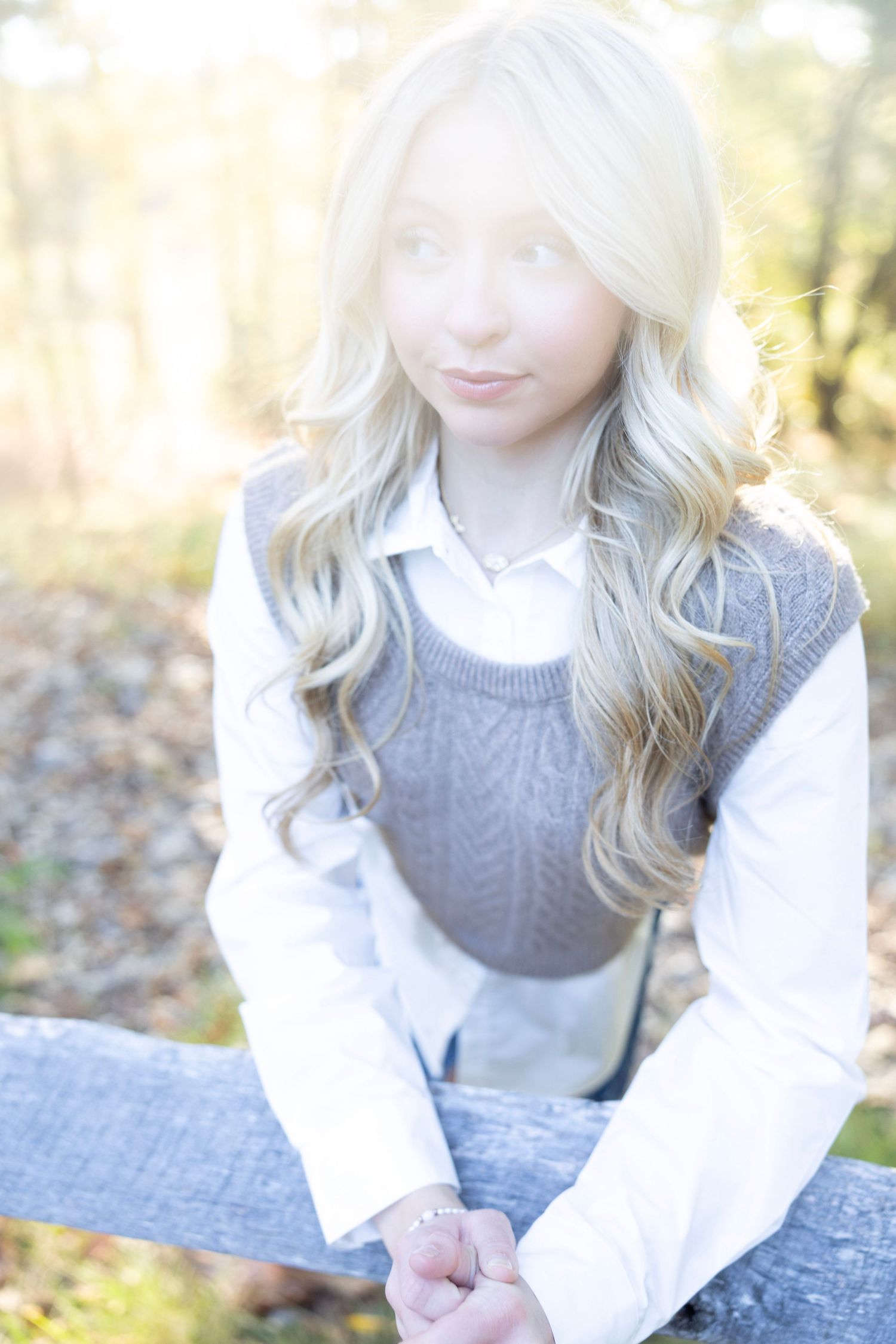 Close-up shots showing gray sweater and white shirt outfit details in natural lighting.