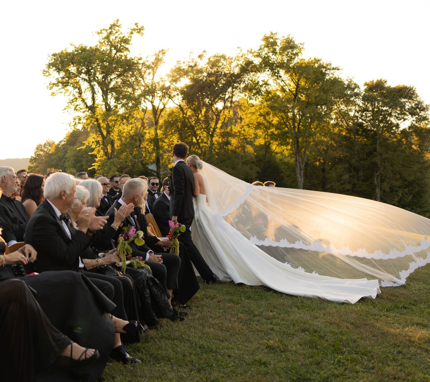 Do you see the happiness from the crowd clapping for the newly weds that just tied the knot.