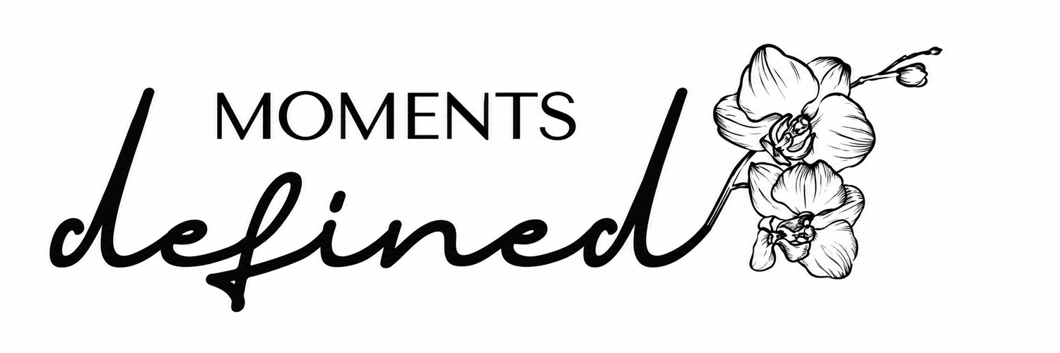 Moments Defined elegant logo with cursive script and delicate orchid flower illustration in black and white.