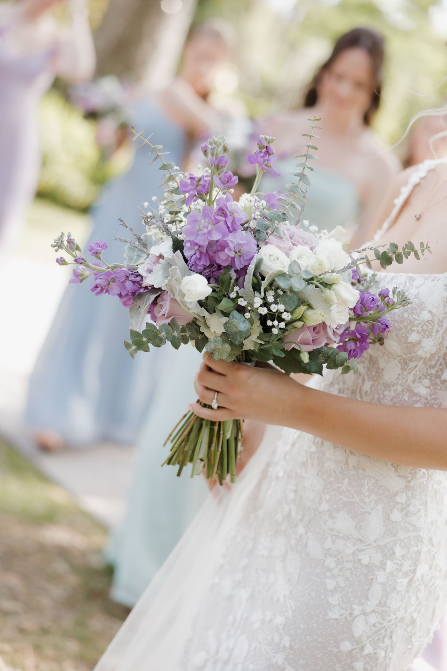Close-up shots of a delicate wedding bouquet featuring purple and white flowers with eucalyptus greenery.