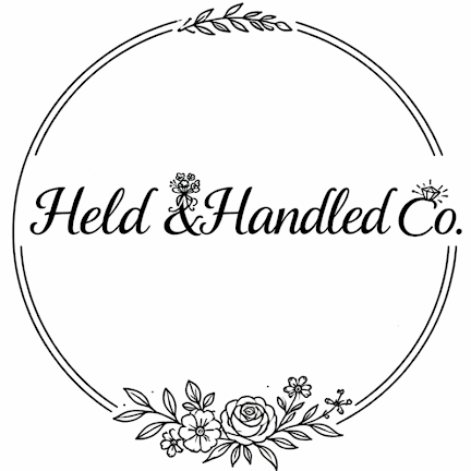Held & Handled Co. logo with floral wreath design in black and white script typography.