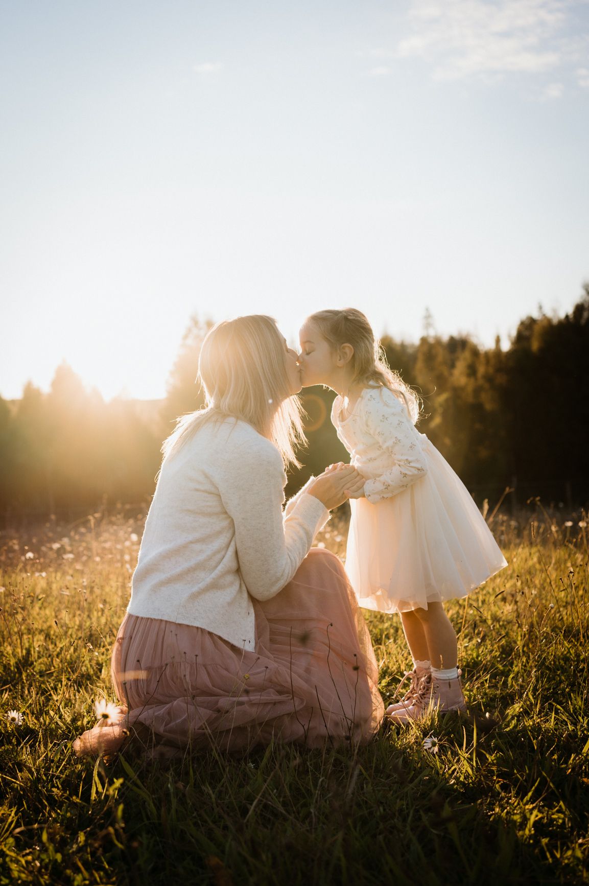 Mama Daughter kisses in golden light