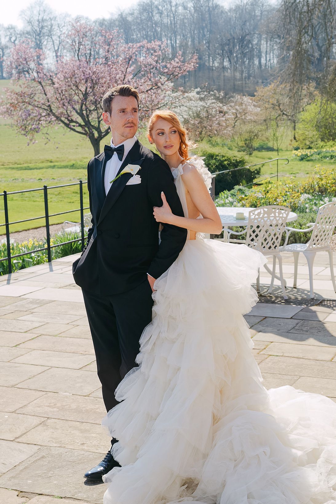 Editorial style portrait of bride and groom at a romantic UK garden wedding venue.