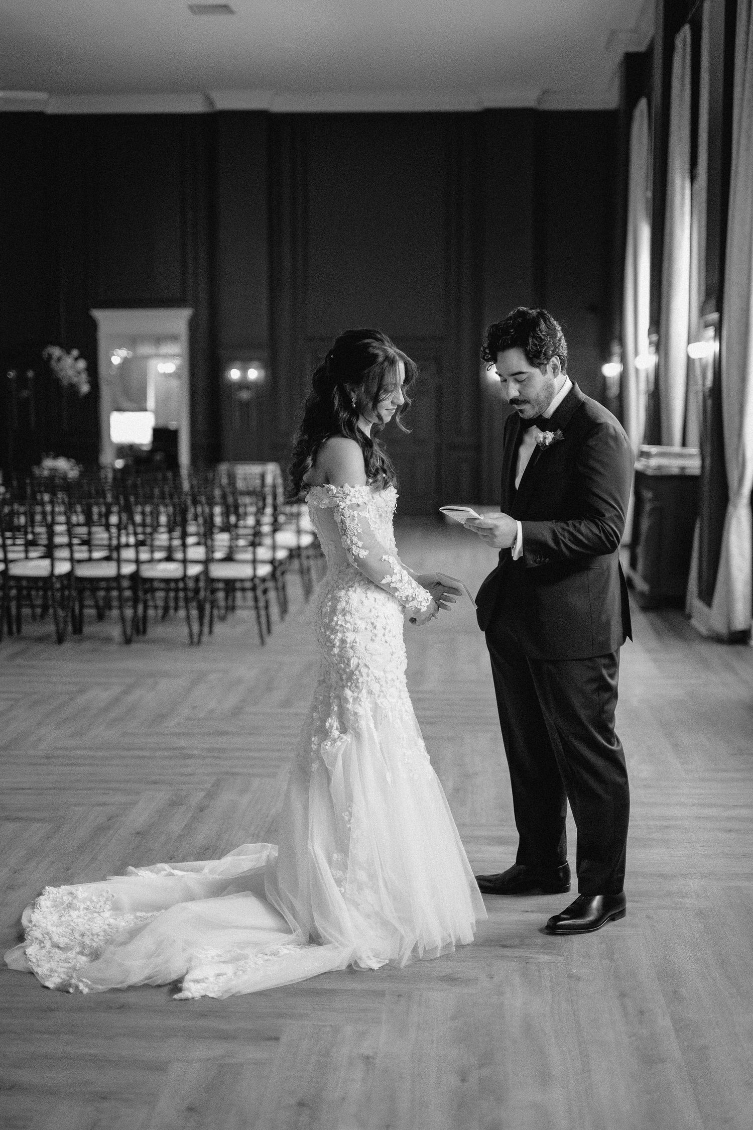 A series of black and white photos showing a couple's first dance at their wedding reception in an elegant ballroom.