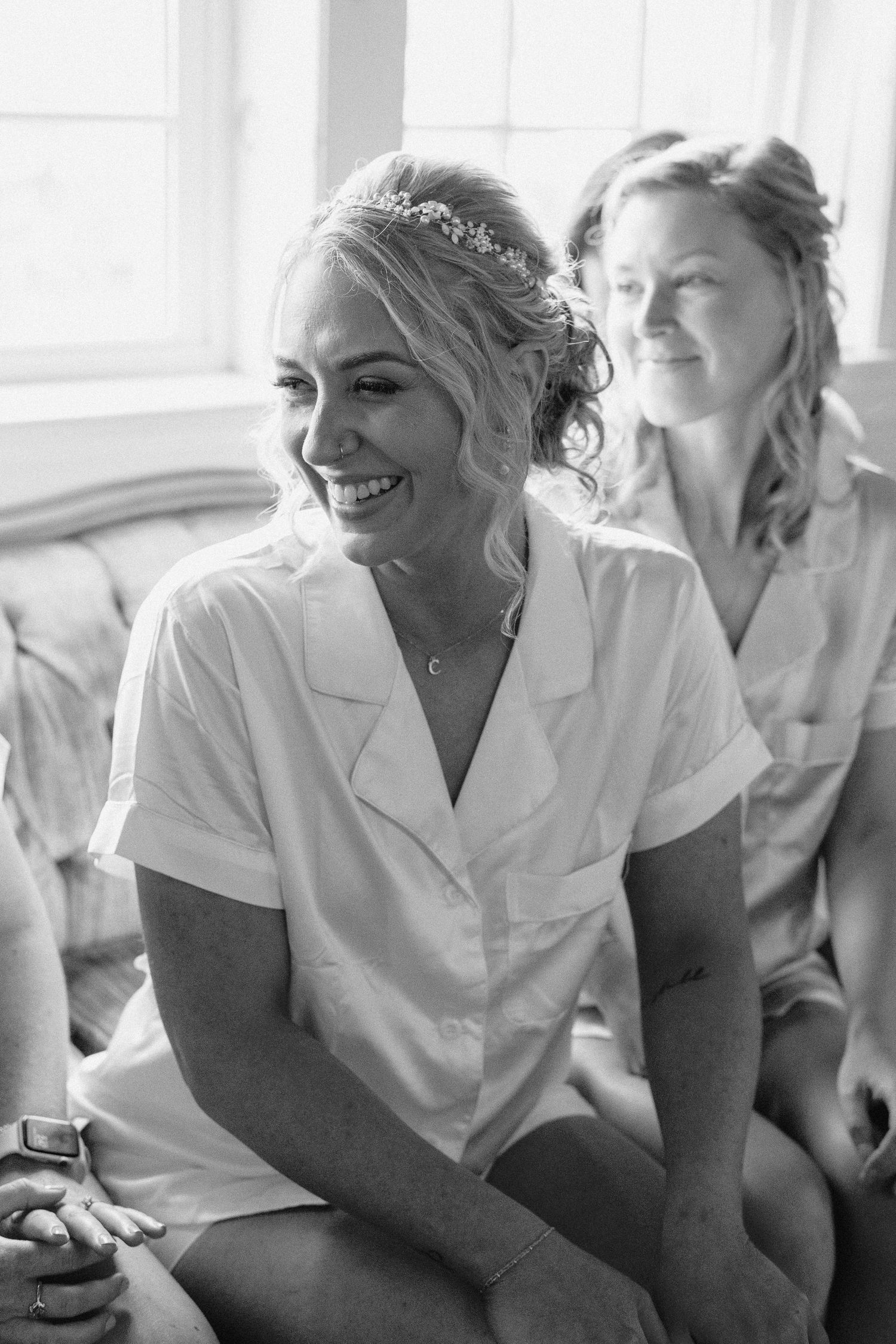 A series of black and white photos showing healthcare workers in white coats sharing joyful moments together.