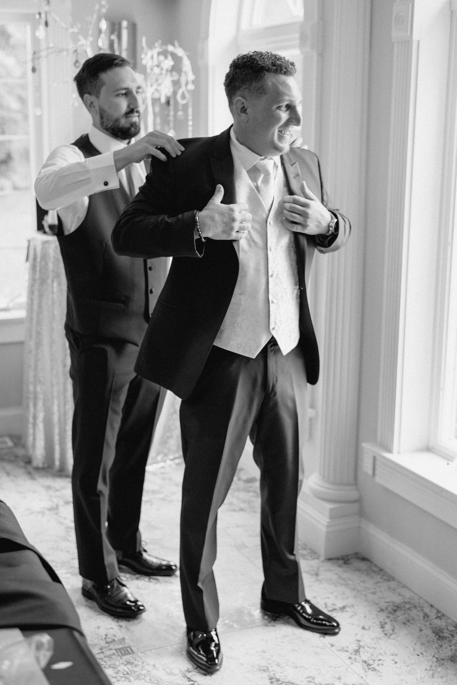 Black and white photo sequence showing groomsmen helping each other put on dress shoes before a wedding ceremony.