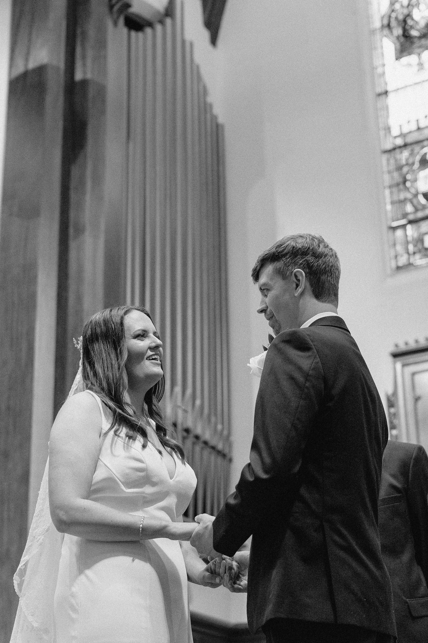 Black and white photo sequence showing a couple dancing and dipping during their wedding dance at an elegant venue.