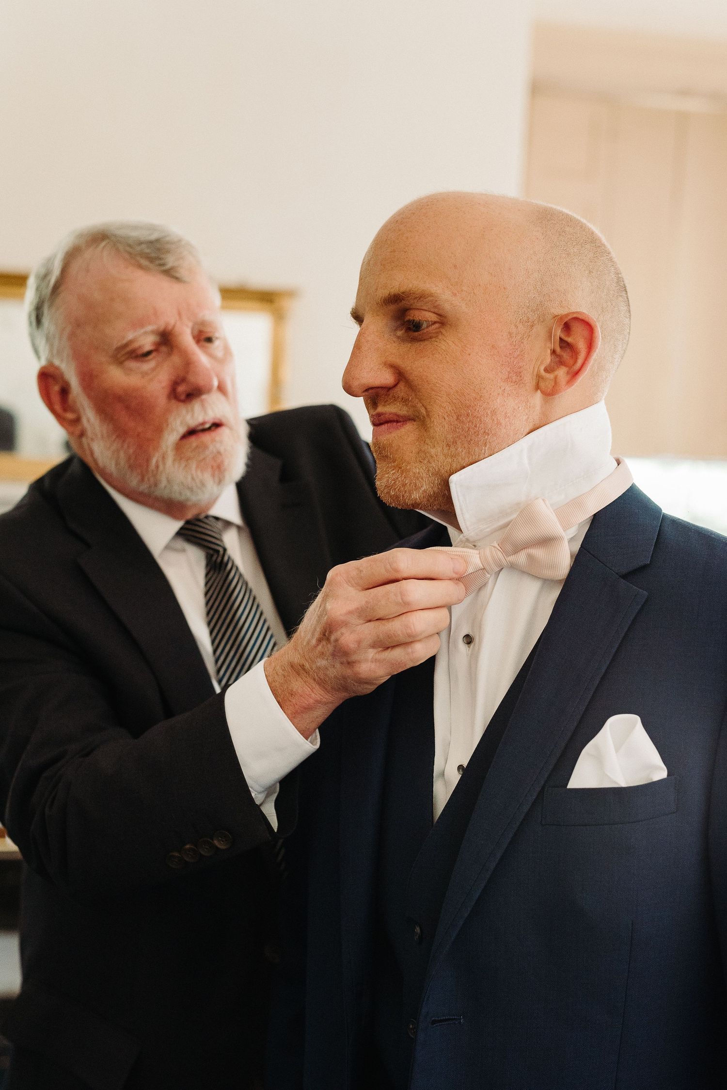 A series of photos showing two men in suits sharing an emotional moment with tissues and handkerchiefs.