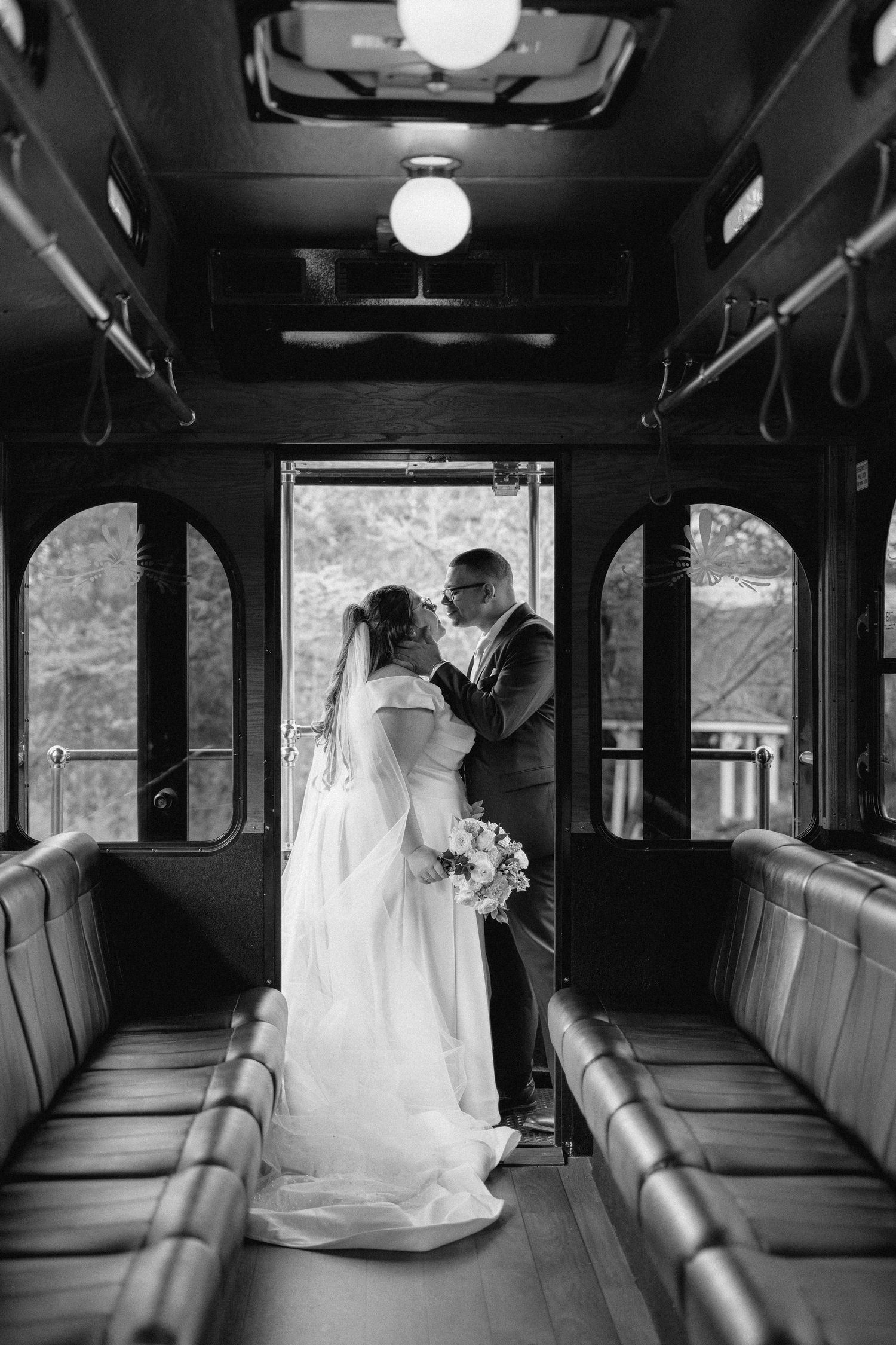 A series of black and white wedding photographs showing tender moments inside a vintage bus interior in Lancaster PA.
