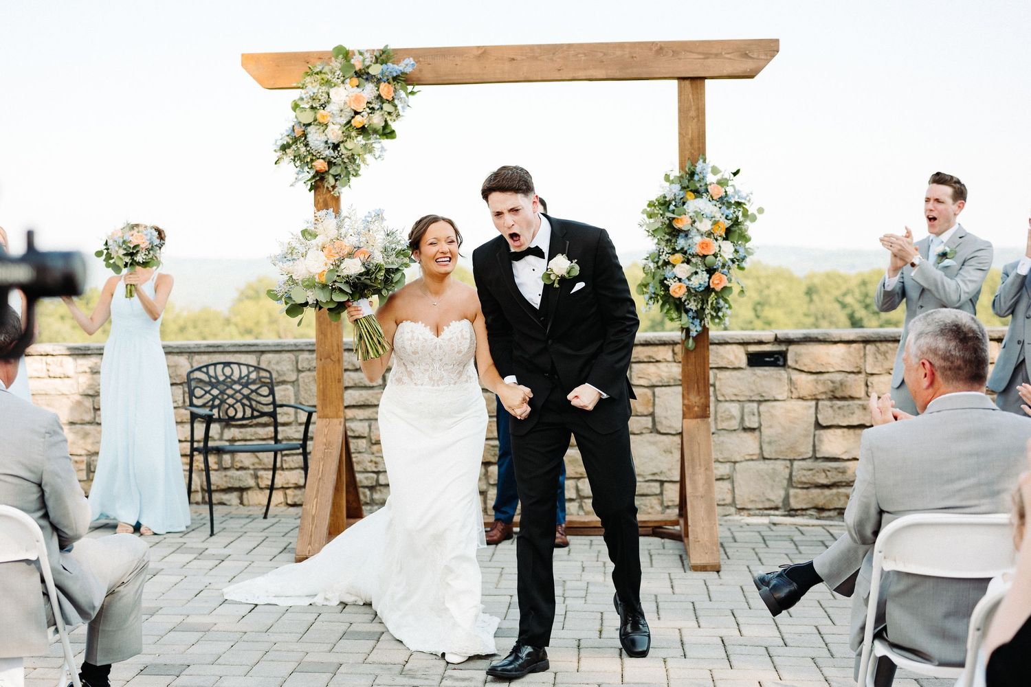 A series of romantic wedding moments captured at a rustic stone venue with decorative floral arrangements.
