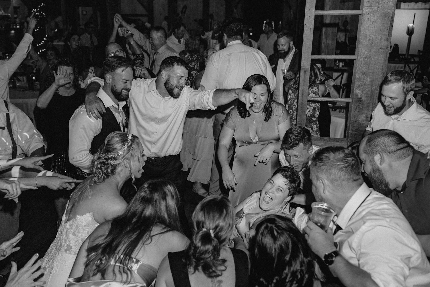 Black and white photo collage showing people dancing and celebrating at what appears to be a wedding reception or party in Berks County PA.