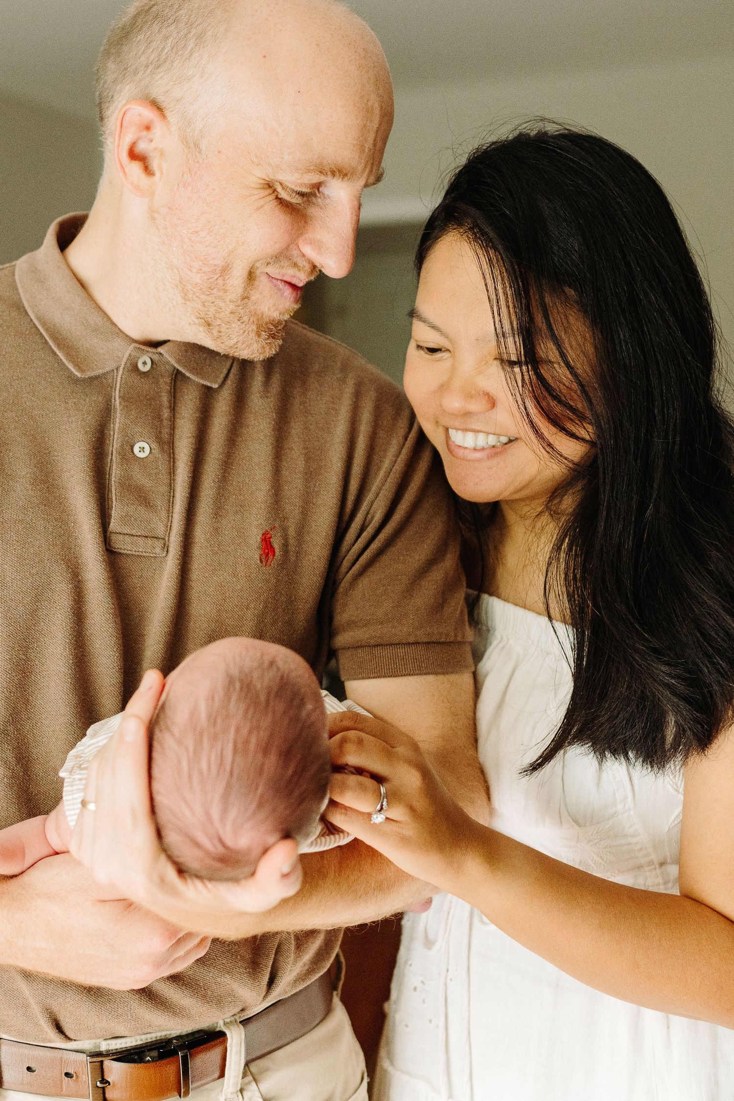 A tender family moment captured in a series of intimate photos showing parents bonding with their newborn baby.