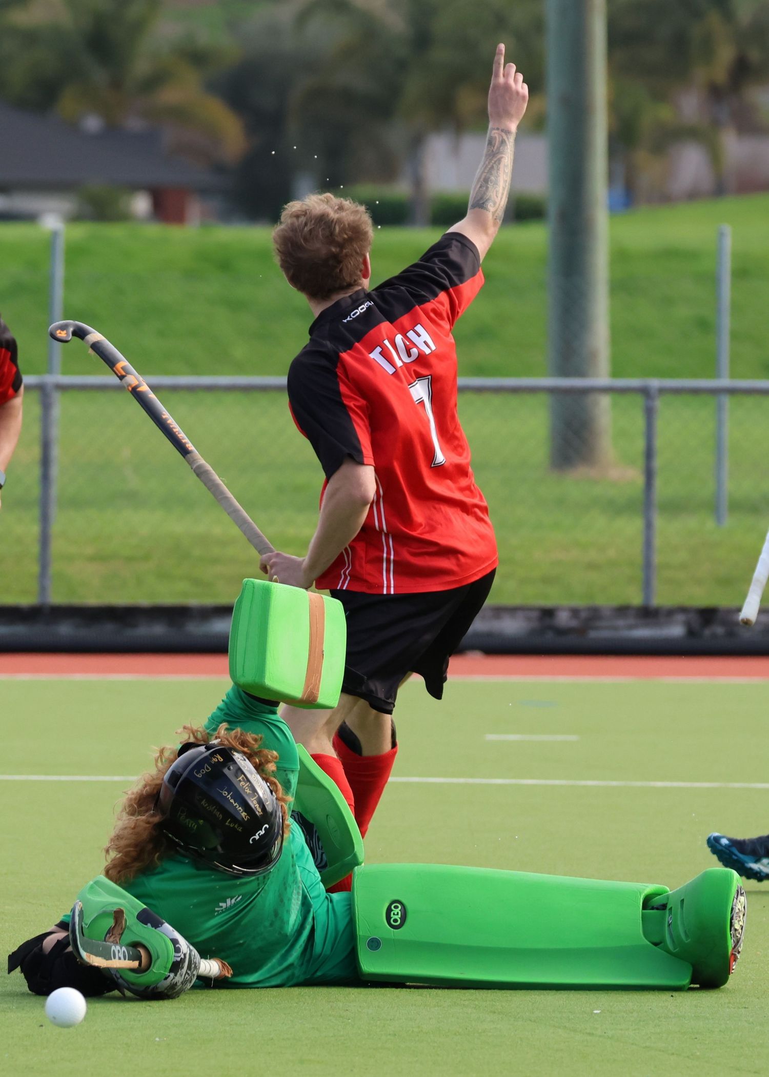 Napier Tech hockey player surprising the goalie who is on the ground.