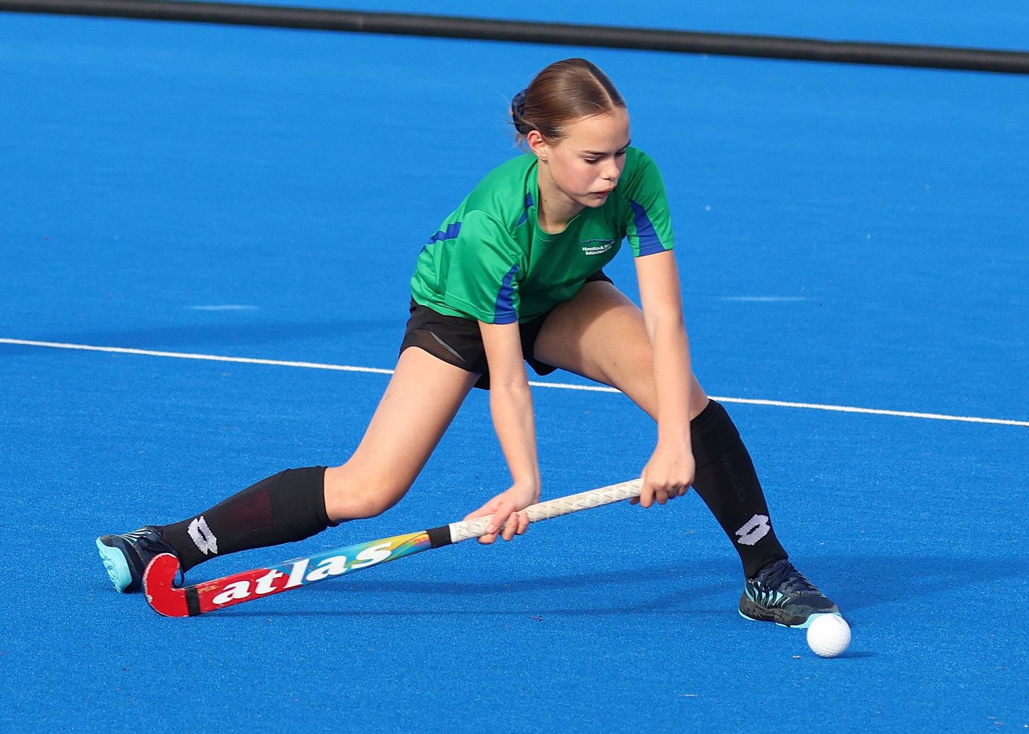 Havelock North Intermediate School hockey player about to pass the ball.