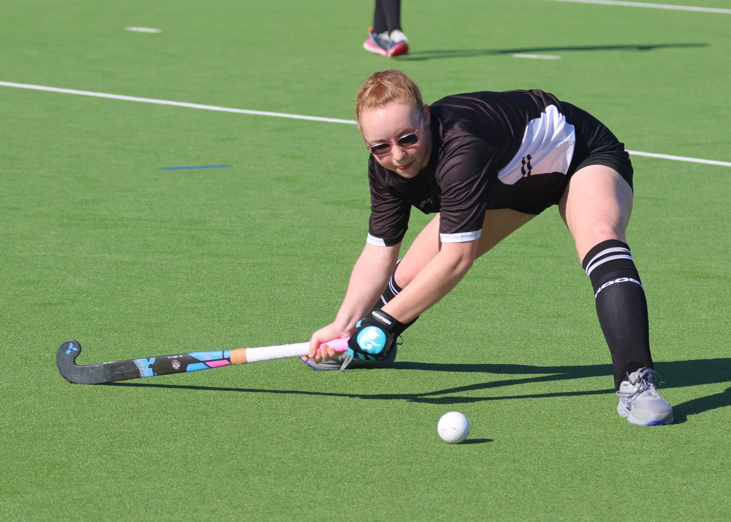 U14 Hawke's Bay player about to slap the hockey ball.