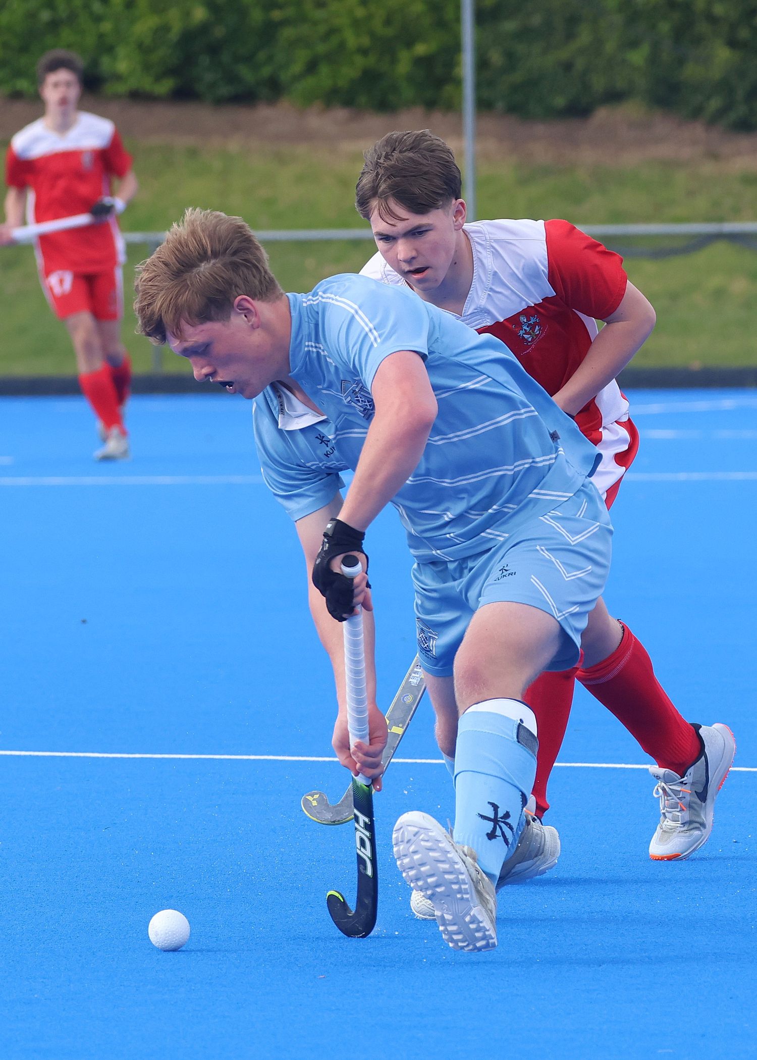 Napier Boys' High School Playing charging down the turf about to pass the hockey ball