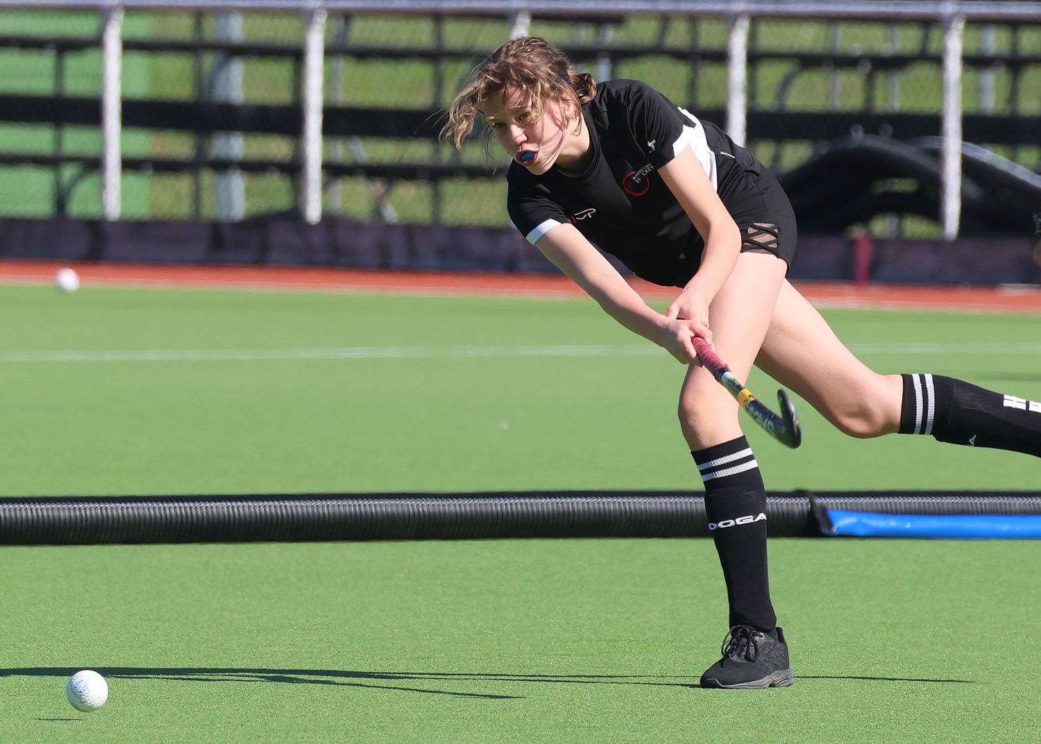 U14 Hawke's Bay player powerfully hitting the ball.