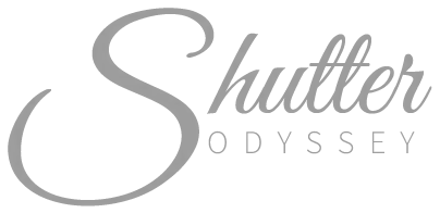 Shutter Odyssey photography logo in elegant gray script and sans-serif typography on white background.