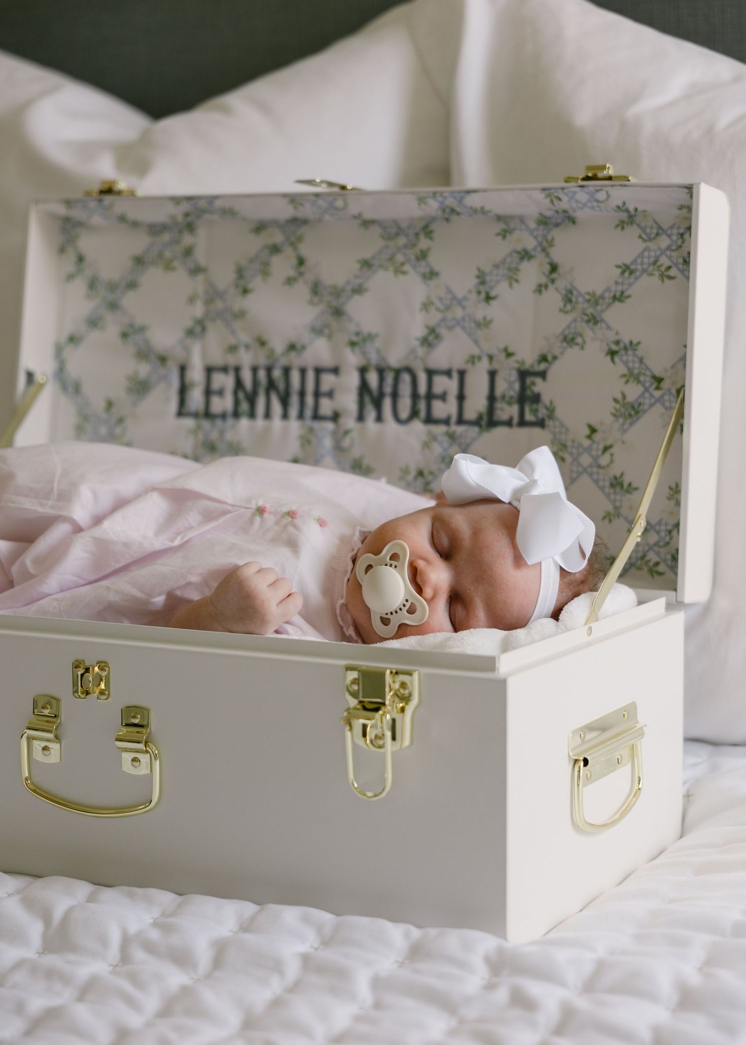 Newborn baby girl named Lennie Noelle resting in a decorative keepsake box.