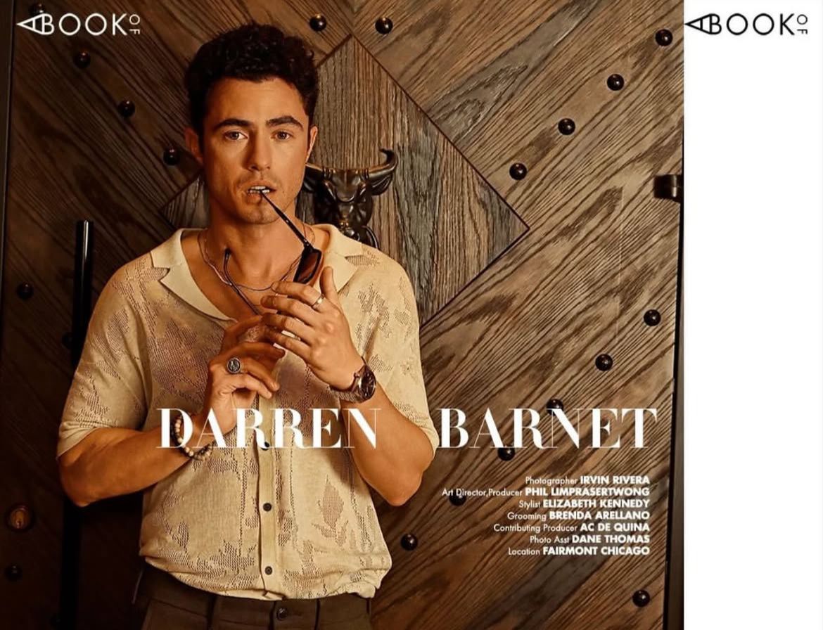 Darren Barnet poses in a light linen shirt holding a pipe, featured in a Book2 magazine editorial shoot.