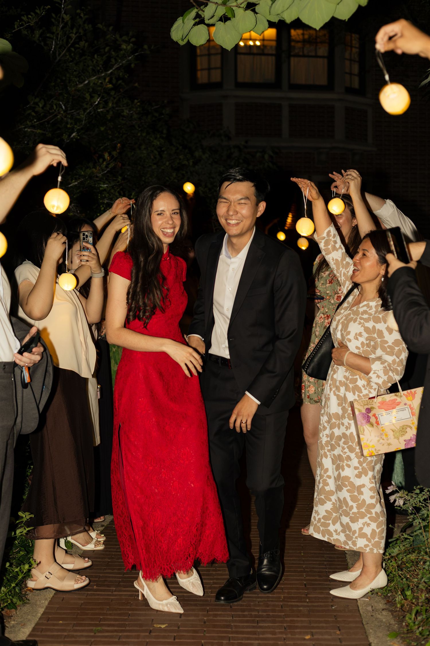 Bride and Groom exiting their wedding reception with guests cheering.