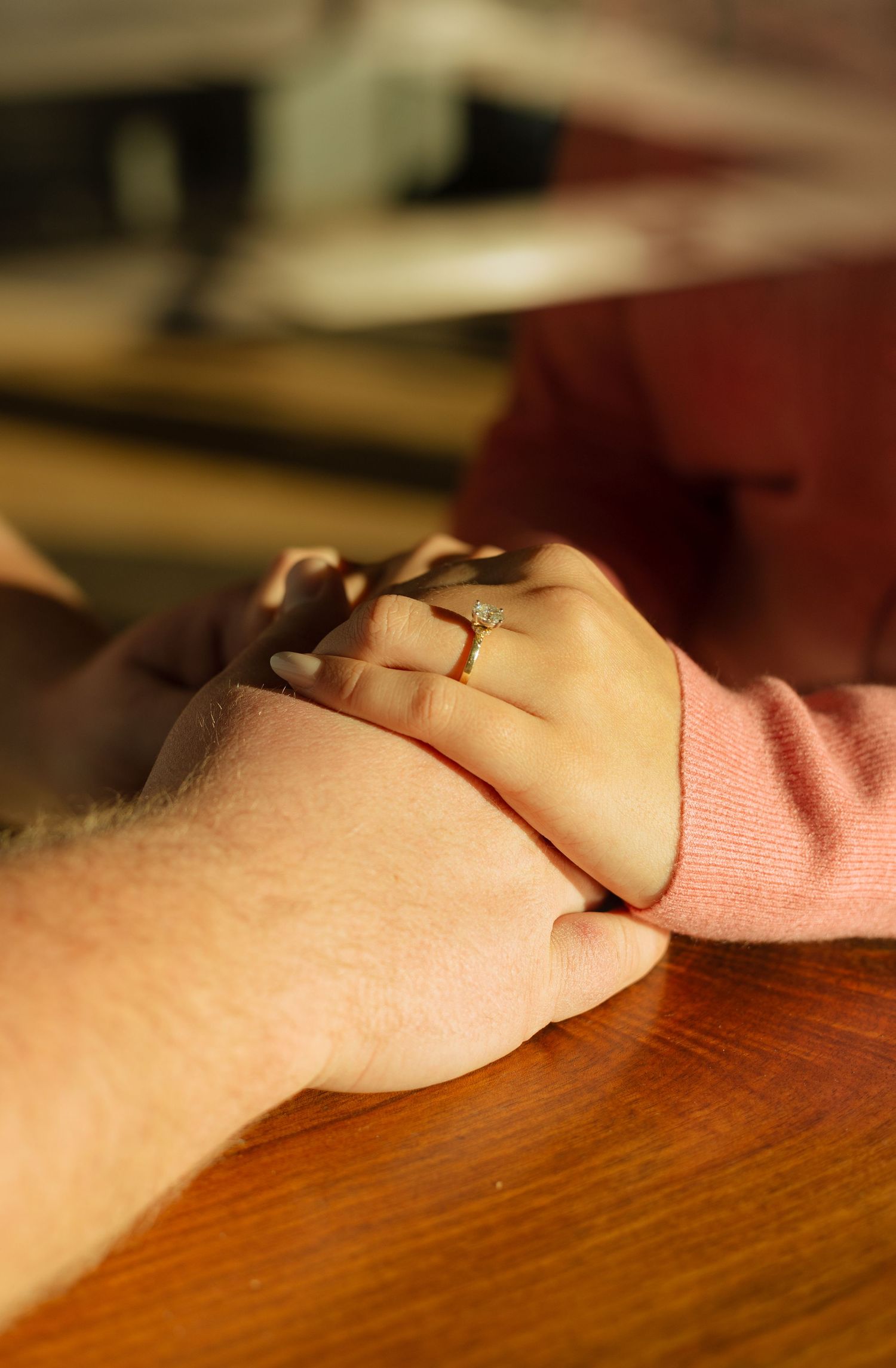 Couple holding hands at coffee shop in Glen Ellyn, Illinois.