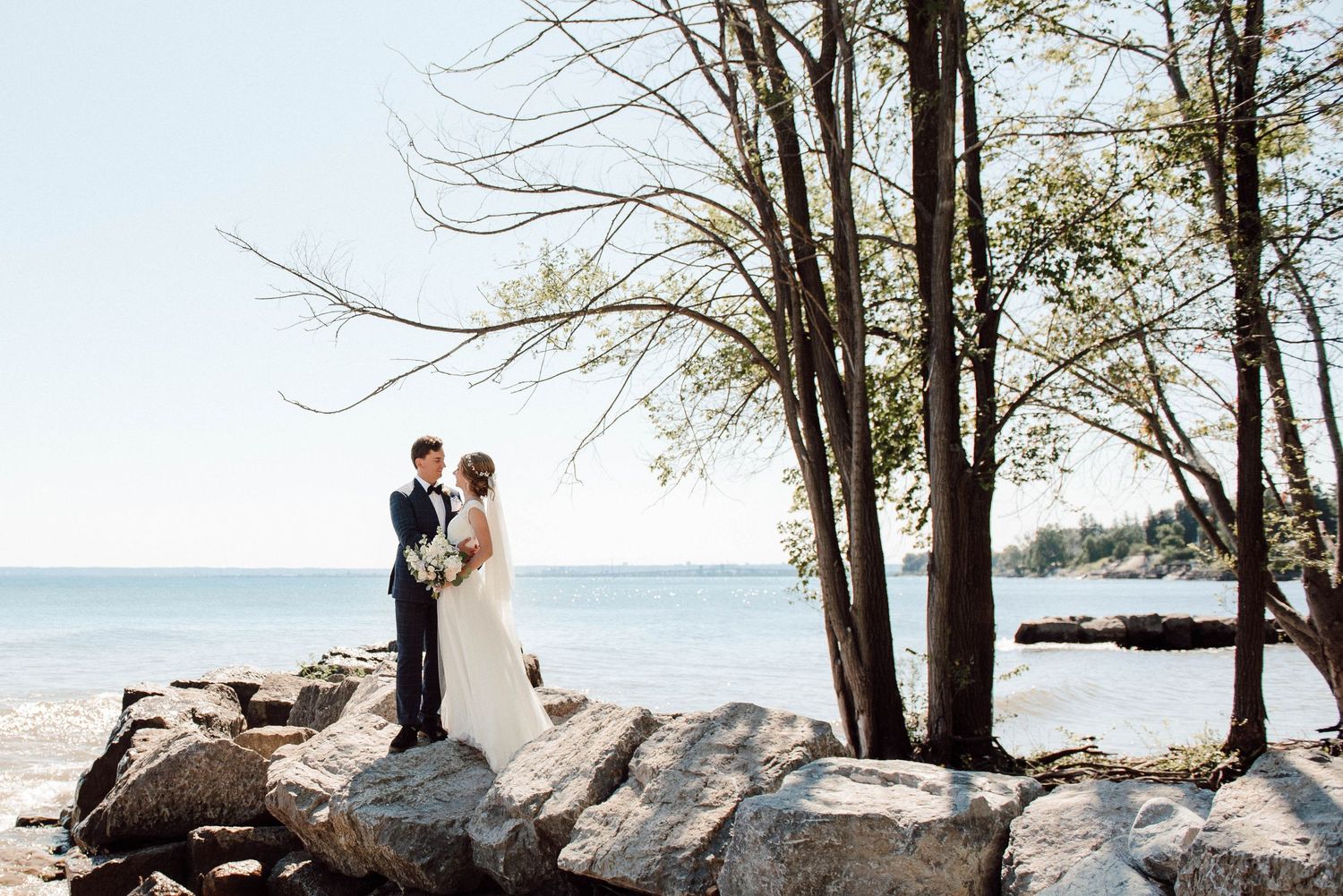 The bride and groom by the lake at Paletta Mansion