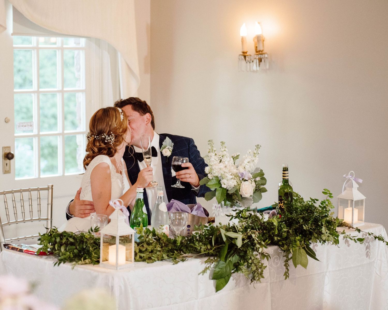 A bride and groom kiss at their reception at Paletta Mansion