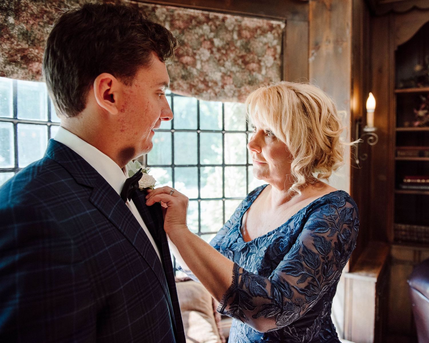 The grooms mother putting his boutonniere on at Paletta Mansion