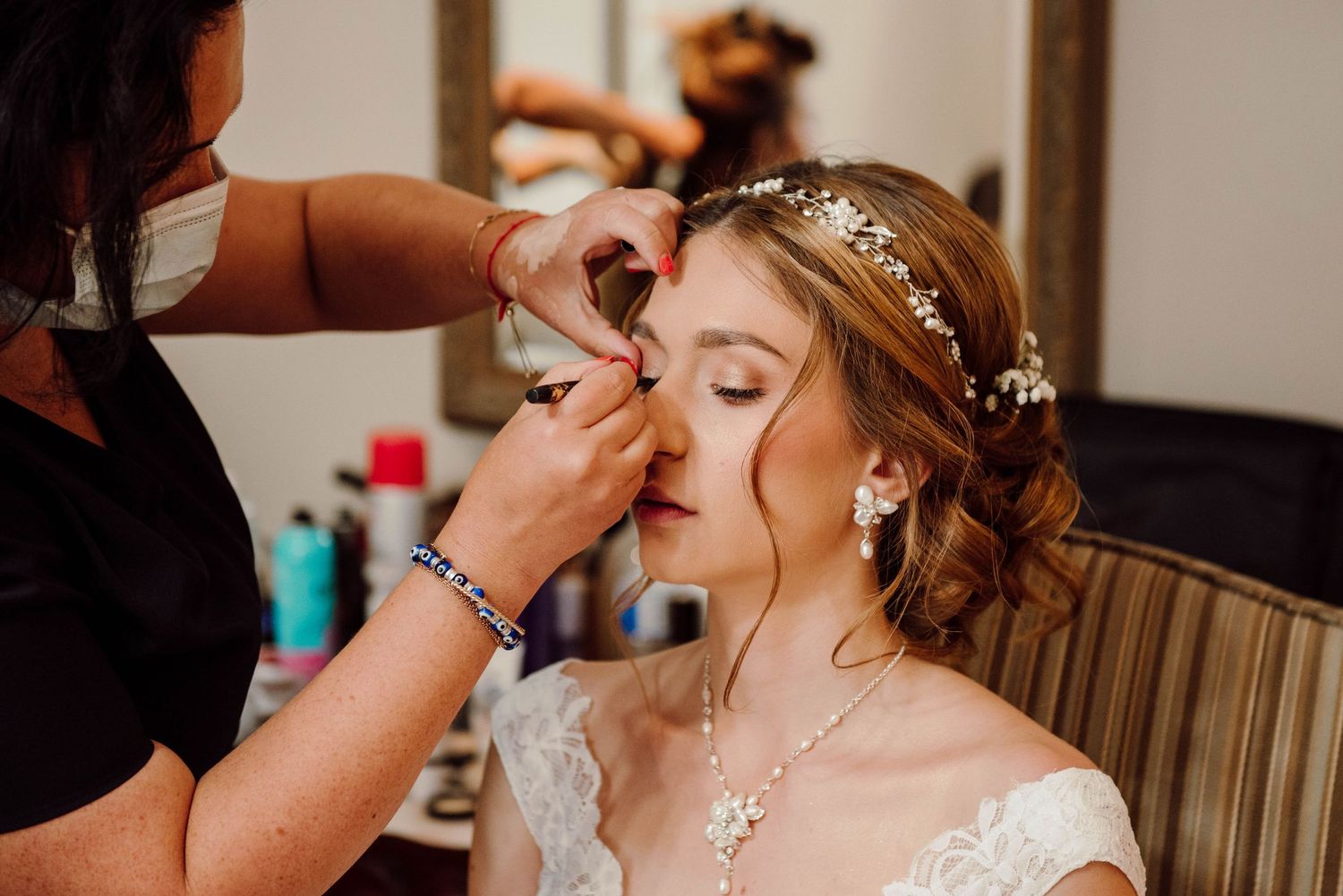 The bride getting her makeup touched up by The Real Beauty Experts at Paletta Mansion