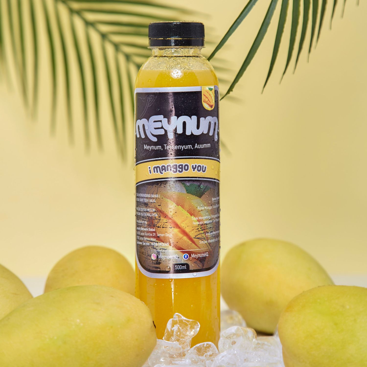 A bottle of Meynum mango juice surrounded by fresh yellow mangoes and ice on a bright yellow background.