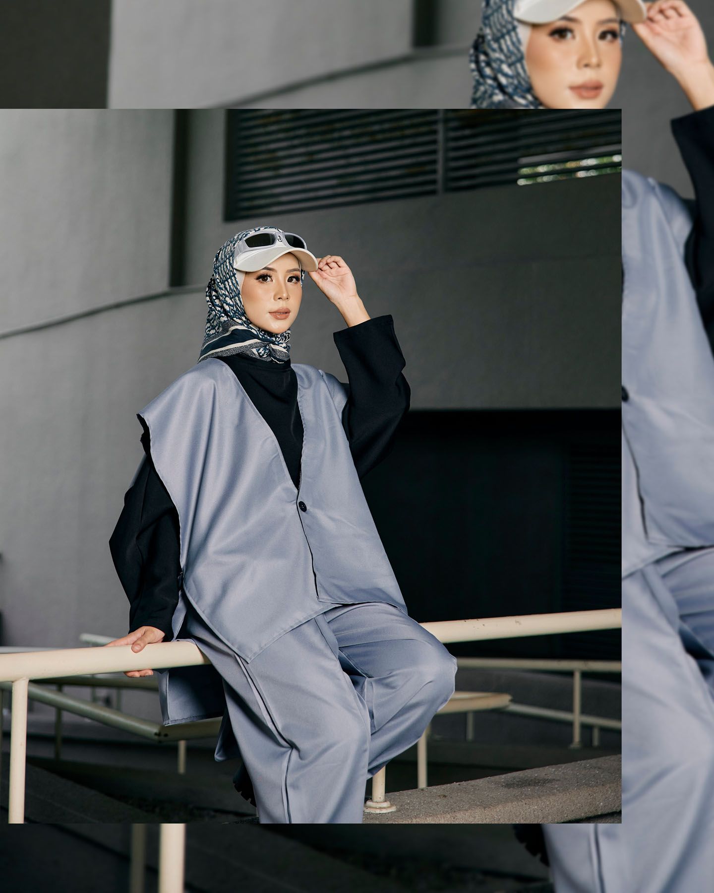 Fashion model wearing gray oversized blazer and wide-leg pants with patterned hijab and sunglasses seated outdoors.