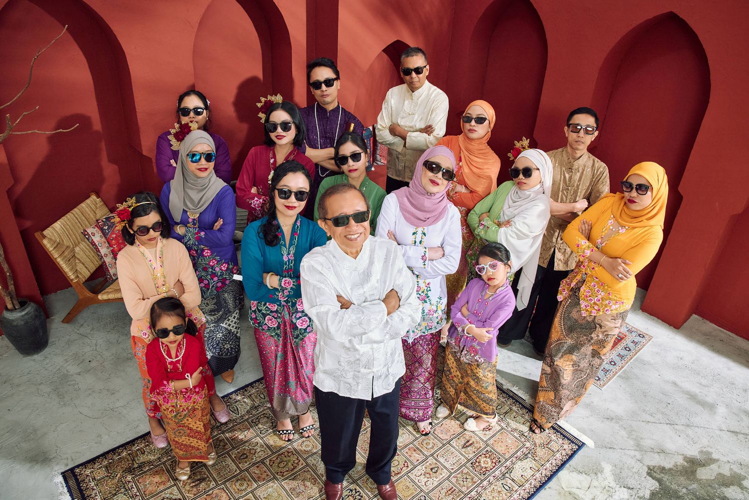 Fun Malaysian family group photo in sunglasses and traditional Kebaya attire for Hari Raya.