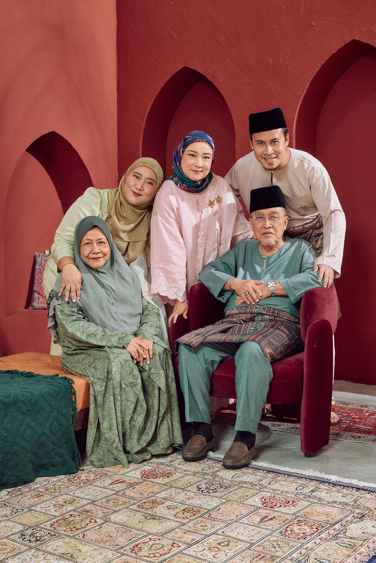 Malaysian family of five in traditional Baju Melayu and hijab celebrating Hari Raya together.