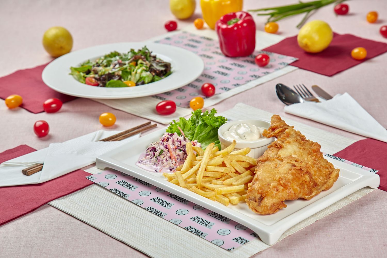 Crispy fried chicken with french fries, coleslaw, and tartar sauce on white plate with side salad.