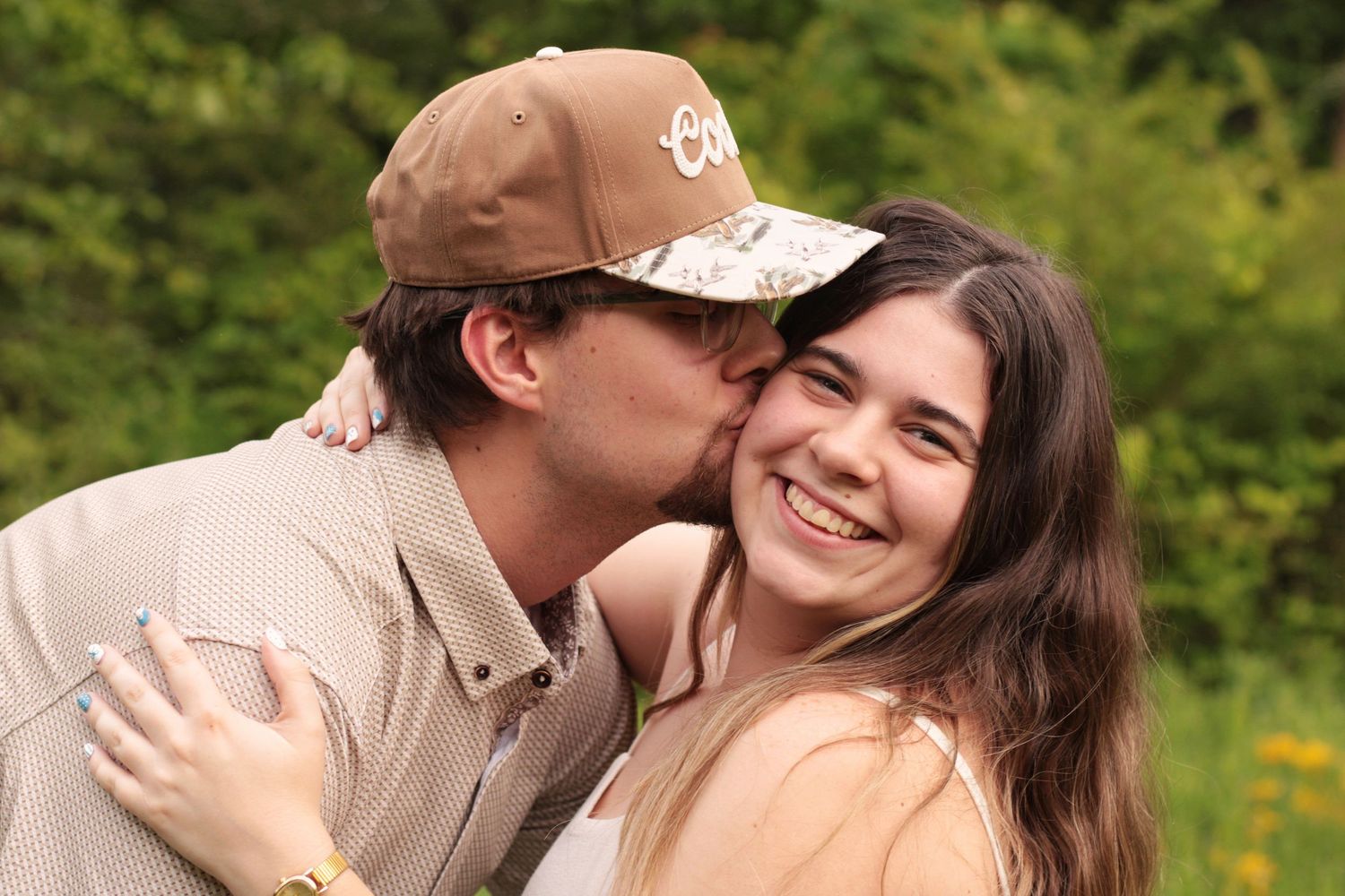 Intimate couple embraces in natural surroundings