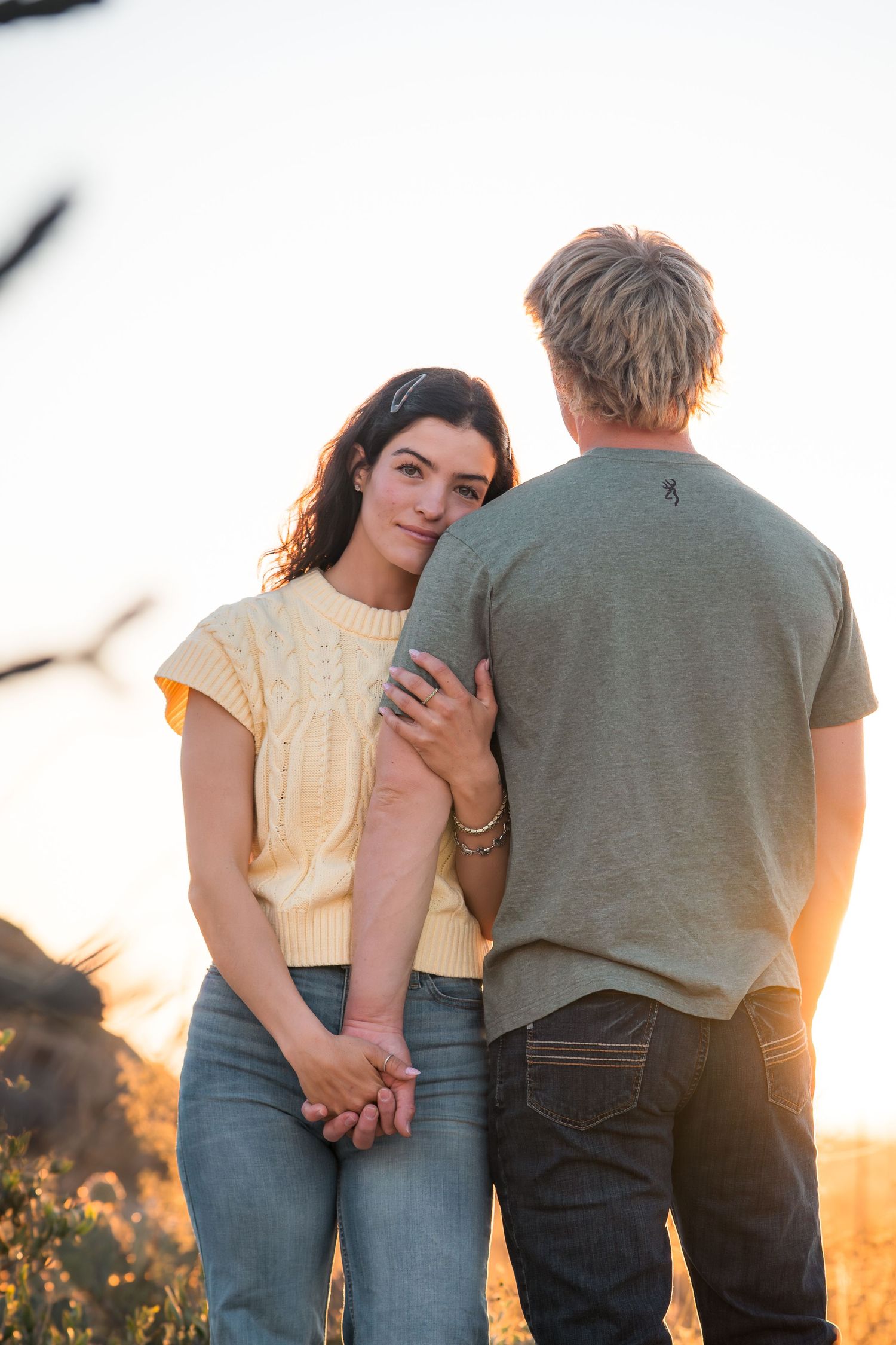 Couple embracing during golden hour in Tucson desert landscape, Arizona engagement session