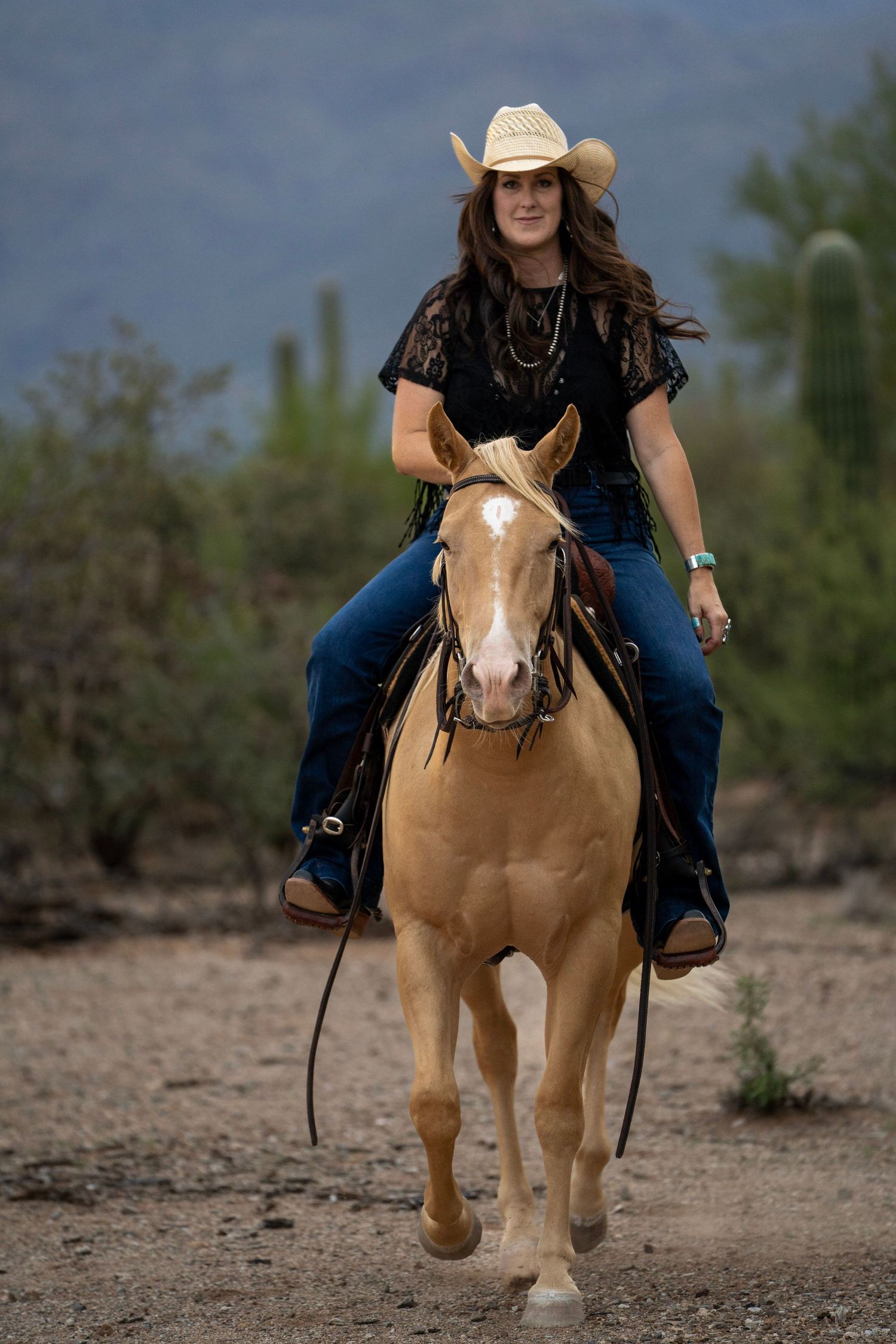 Cowgirl riding her horse in the desert